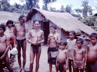 As I recall, the gentleman in the center holding what appear  to be sticks in his hands was the group "leader".  The sticks he is  holding are actually the parts to a crossbow which I bought from him for $3.00 worth of Piasters.....I still have the crossbow!!